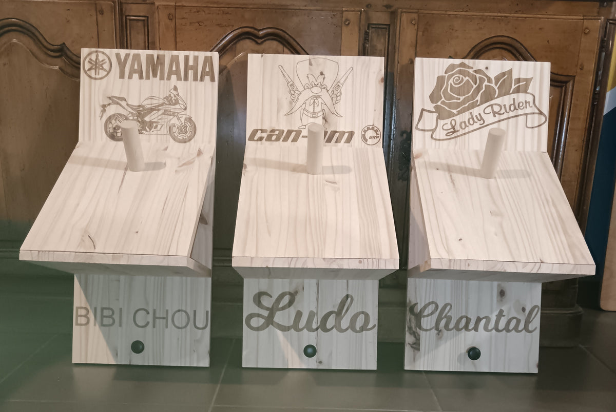 Trois supports de casque moto en bois avec tablettes, motifs gravés différents et prénoms personnalisés
